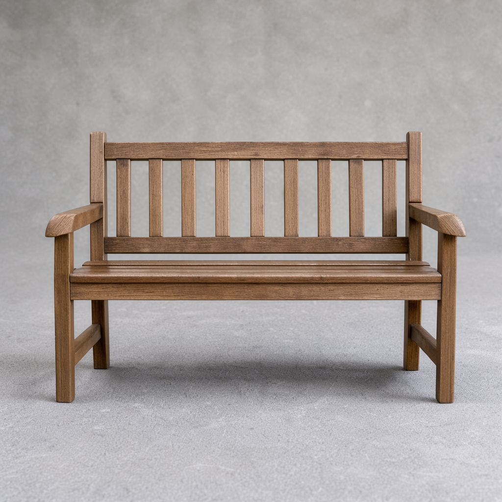 A slatted wooden bench against a plain grey wall